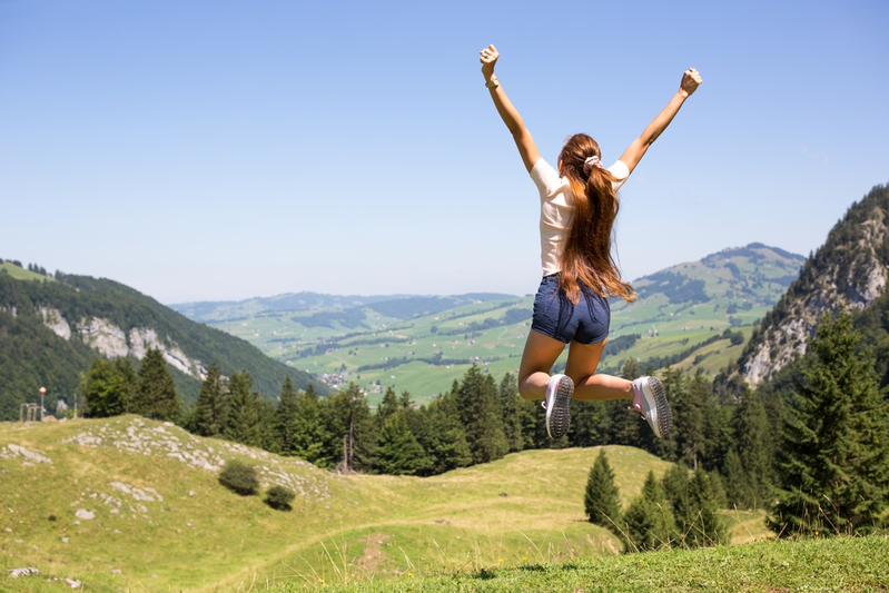 woman jumping in air outdoors