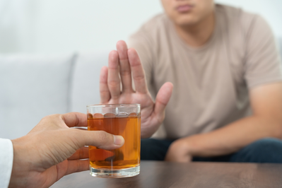 man rejecting alcoholic drink